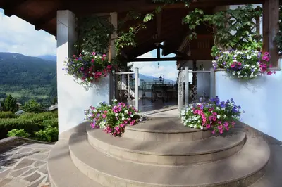 a house with flowers on the front of it at B&B Magiré in Tesero