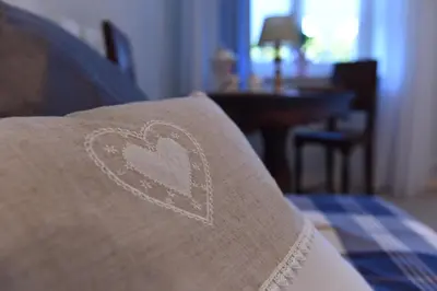 a heart drawn on a blanket on a bed at B&B Magiré in Tesero