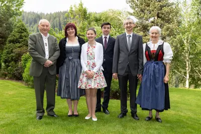 a group of people standing in the grass at Gasthof Specker in Obereggen