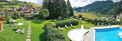 a resort with a swimming pool and a resort at Residence Comploj in Santa Cristina in Val Gardena