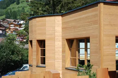 a wooden house with windows on a building at Residence Comploj in Santa Cristina in Val Gardena