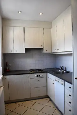 a kitchen with white cabinets and a stove top oven at Residence Comploj in Santa Cristina in Val Gardena