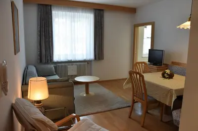 a living room with a couch and a table at Residence Comploj in Santa Cristina in Val Gardena