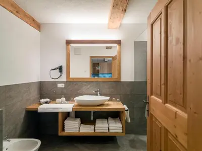 a bathroom with a sink and a mirror at Bruggerhof Prags in Braies