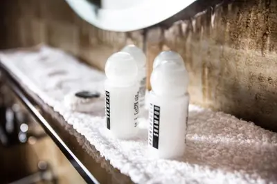 two bottles of sunscreen sitting on a counter covered in snow at Residence Rienz in Chienes
