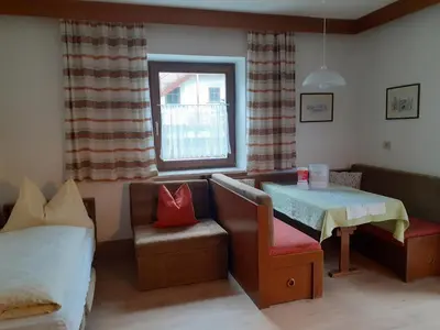 a room with a bed and a table and a chair at Residence Rienz in Chienes