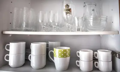 a bunch of cups and glasses on a shelf at Residence Rienz in Chienes
