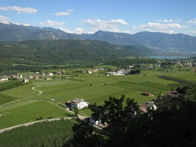 a small town in a green valley with mountains at Rebhof Kaltern in Caldaro