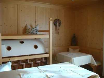 a room with a bed and a bath tub in it at B&B Haus Grüner in Valdaora