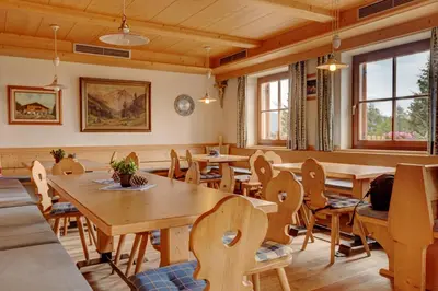 a dining room with wooden tables and chairs at Gasthaus Furlhütte in Vipiteno