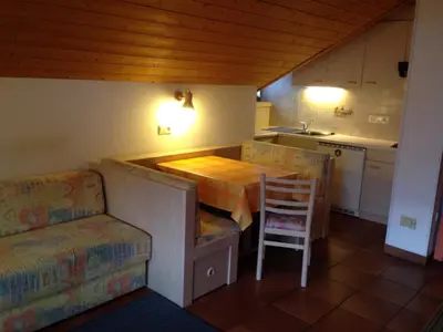 a small kitchen with a table and a chair at Schuster Emma in Valdaora