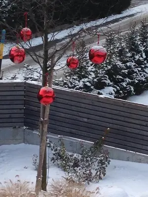 a tree with red decorations on it in the snow at Schuster Emma in Valdaora