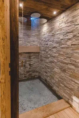 a stone walled shower in a log cabin at Wegscheiderhof in Feldthurns