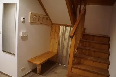 a staircase in a room with a wooden stair case at Wegscheiderhof in Feldthurns