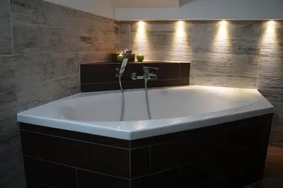 a bath tub in a bathroom with a sink at Wegscheiderhof in Feldthurns