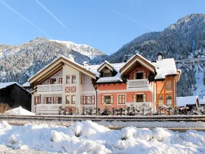 a house covered in snow in front of a mountain at Apartment Giovanni - CPO359 by Interhome in Campitello