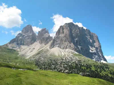 a mountain with a green field in front of it at Apartment Giovanni - CPO359 by Interhome in Campitello