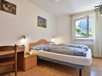 a bedroom with two bunk beds and a balcony at Apartment Cecilia-2 by Interhome in Campitello