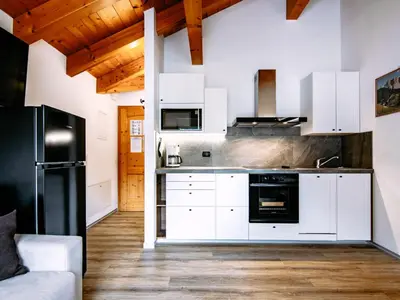 a living room with a table and a couch at Apartment Cecilia-3 by Interhome in Campitello