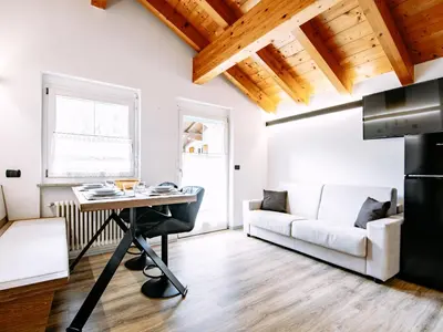 a kitchen with a table and chairs in a room at Apartment Cecilia-3 by Interhome in Campitello