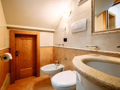 a bathroom with a toilet and a sink and a tub at Apartment Cecilia-3 by Interhome in Campitello