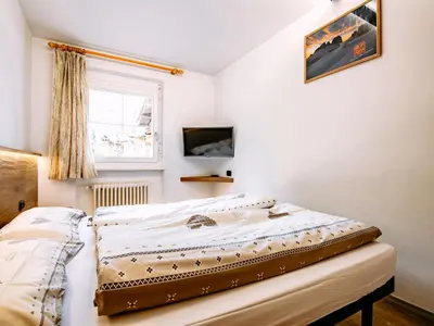 a bedroom with a bed and a closet at Apartment Cecilia-3 by Interhome in Campitello