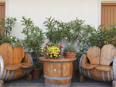 a group of wooden chairs and a table with flowers at Apartment Neuhaus by Interhome in Andrian