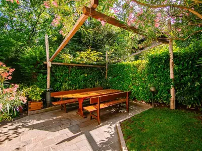 a wooden table and bench in a garden at Apartment Neuhaus by Interhome in Andrian