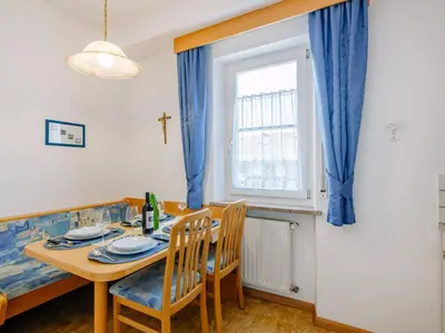 a dining room with a table and chairs and a window at Apartment Neuhaus by Interhome in Andrian