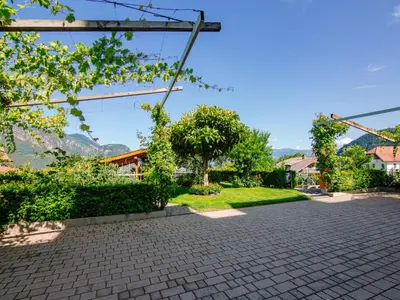 a brick driveway with trees and a house at Apartment Hocheppan by Interhome in Andrian