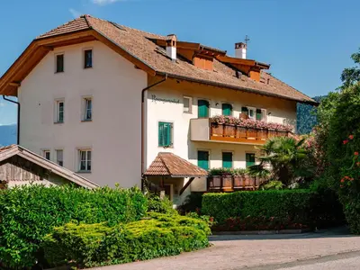 a large white building with a tile roof at Apartment Festenstein by Interhome in Andrian