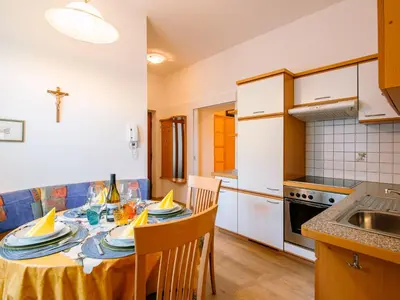 a kitchen with a table and chairs in a room at Apartment Wolfsthurn by Interhome in Andrian