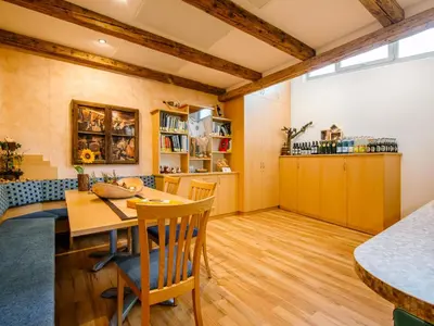 a kitchen and dining room with a table and chairs at Apartment Wolfsthurn by Interhome in Andrian