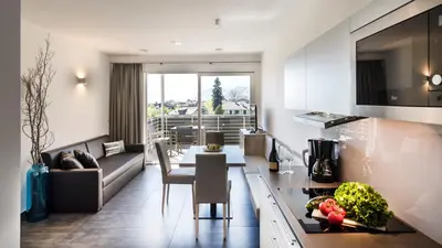a kitchen and living room with a table and a couch at Haus Wiesenstein in Lana
