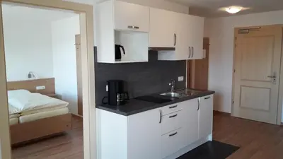 a kitchen with a sink and a bed in a room at Residence Vellauerhof in Lagundo