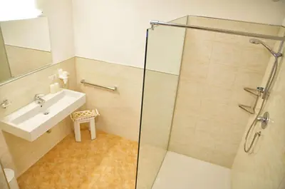 a bathroom with a sink and a glass shower at Residence Vellauerhof in Lagundo