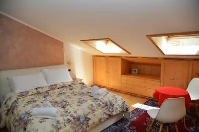 a bedroom with a bed with two stuffed animals on it at Hotel Marianna in Rocca Pietore