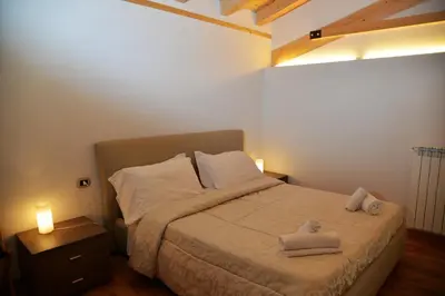 a bedroom with a bed with two towels on it at Hotel Marianna in Rocca Pietore