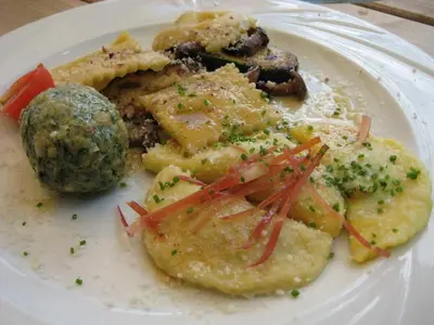 a white plate of food with potatoes and vegetables at Hotel Marianna in Rocca Pietore