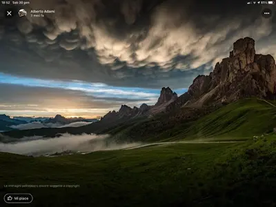 a view of a mountain range with a foggy field at Cesa Fossal in Colle Santa Lucia