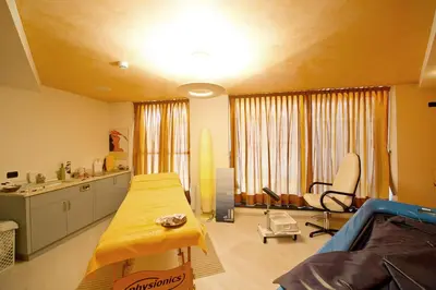 a living room with a couch and a table in it at Family & Wellness Hotel Fontana in Vigo di Fassa