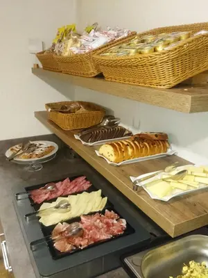 a bunch of different types of food on shelves at Hotel Nès Crépes in Pozza di Fassa