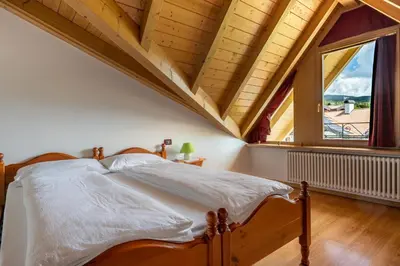 a bedroom with a bed and a large window at Agritur Cristina in Coredo
