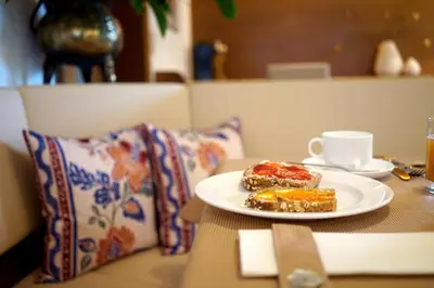 a plate of food and a cup of coffee on a table at Untermairhof B&B Christine in Lagundo