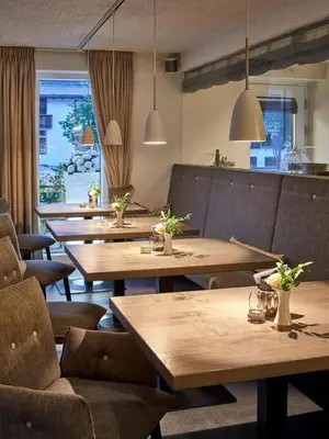 a row of tables and chairs in a restaurant at Ciasa Verena in Corvara in Badia