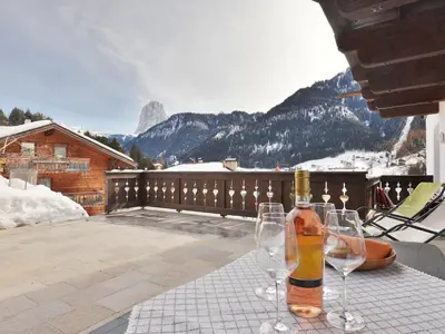 a large white building with a balcony and snow at Apartment Tirol-2 by Interhome in Ortisei