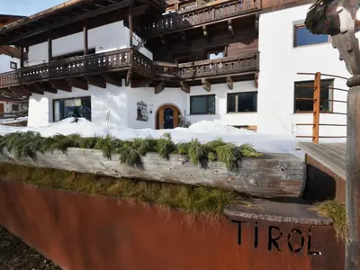 a house with snow and trees on the side of it at Apartment Tirol-2 by Interhome in Ortisei