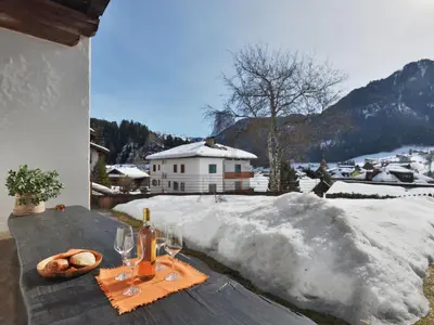 a house with red flowers on the front of it at Apartment Tirol-3 by Interhome in Ortisei