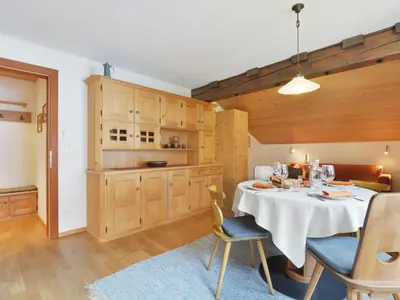 a table with wine glasses and bread on it with snow at Apartment Tirol-3 by Interhome in Ortisei
