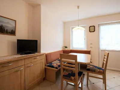 a living room with a couch and a dining room table at Apartment Ornella-1 by Interhome in Santa Cristina in Val Gardena